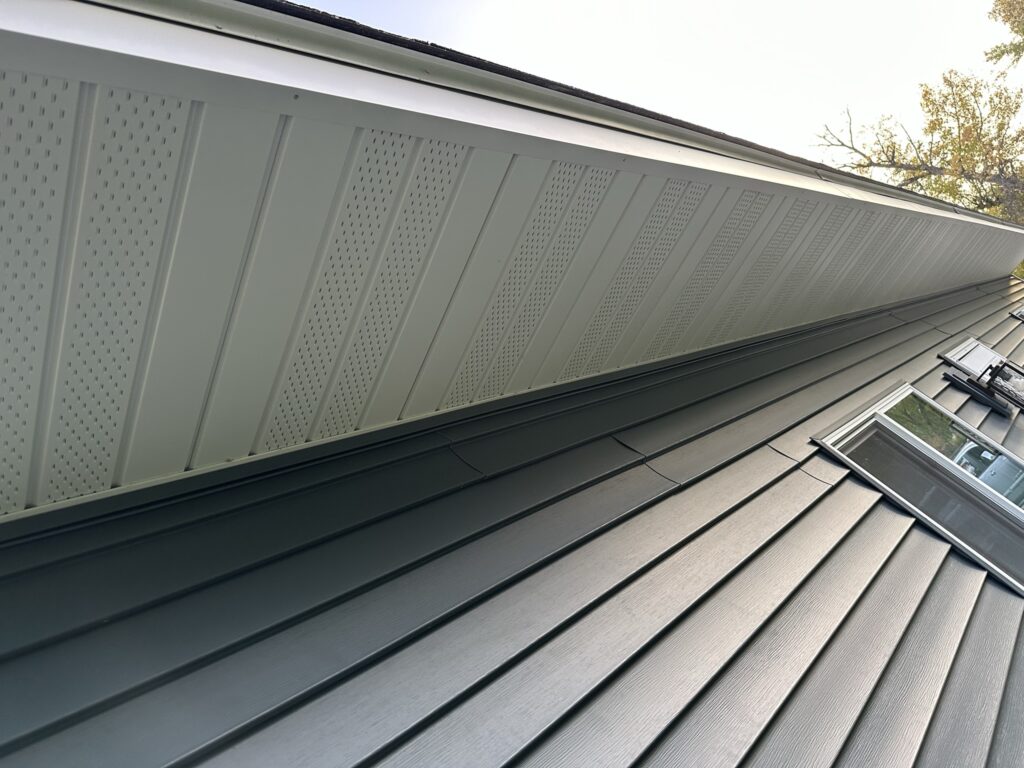 Vented soffit and custom-bent fascia — the soffit keeps the attic breathing, and the fascia is brake-formed on site to fit tight and shed water clean.